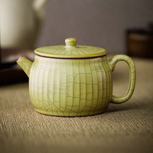Ge Kiln wide-mouth teapot set, elegant Chinese ceramic design for brewing tea.