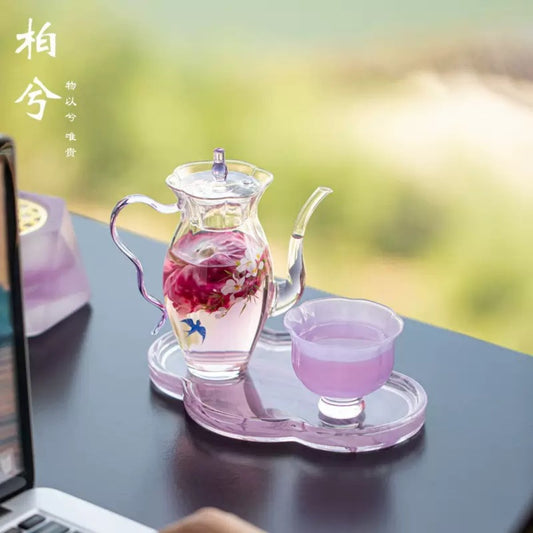 Elegant glass tea set with teapot, cup and tray, modern minimal tea set