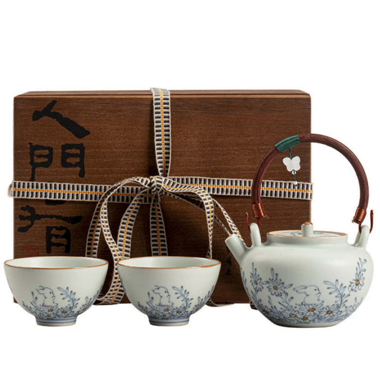 Underglaze blue porcelain teapot set with bamboo handle, matching cups, and wooden gift box