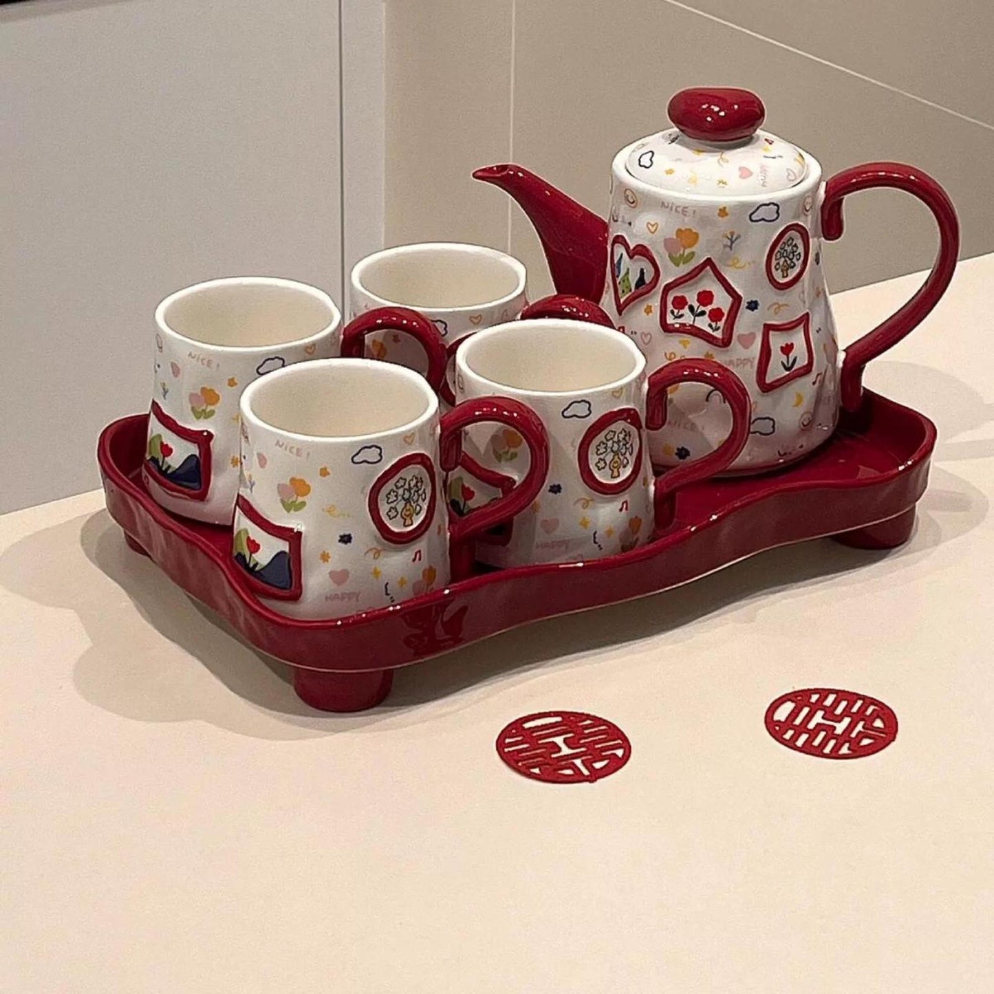 High-fired ceramic 6-piece teapot and tea cup gift set with red music note and creative graffiti design, including 800ML pot, 4 cups, and tray in premium boxed packaging