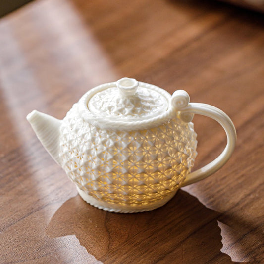 Handmade white porcelain woven teapot with artisan design